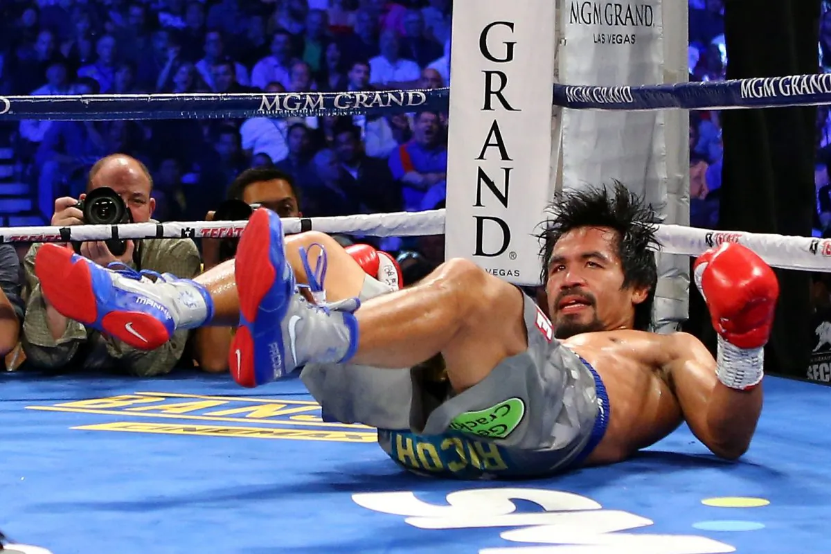 Manny Pacquiao is knocked down in the third round while taking on Juan Manuel Marquez during their welterweight bout at the MGM Grand Garden Arena on December 8, 2012 in Las Vegas, Nevada. (l Bello/Getty Images)