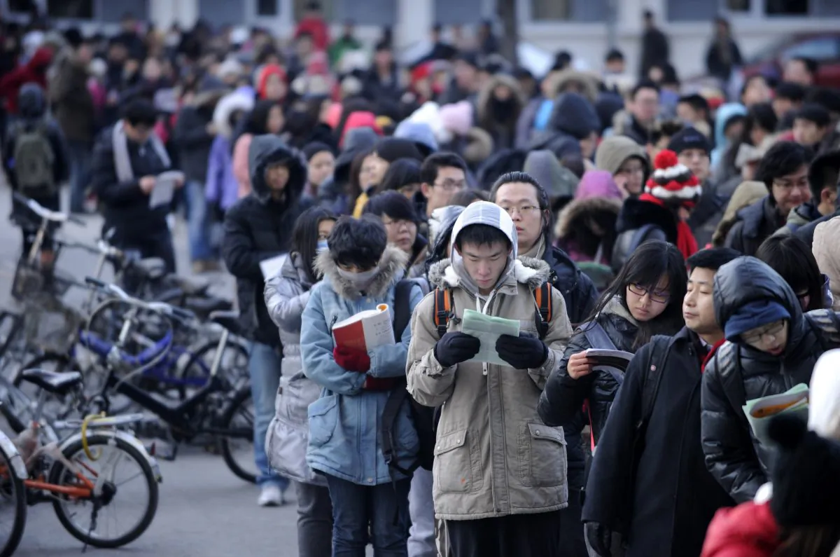 This photo, from Jan. 5, 2013, shows candidates waiting to enter into the exam room to sit the National Entrance Examination for Postgraduate (NEEP) at a university in Beijing. A new directive is ordering local education agencies and Party organizations at universities to strengthen the ideological and political education of young university instructors. (Wang Zhao/AFP/Getty Images)