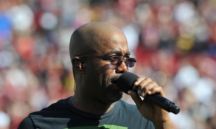 Darius Rucker sings the National Anthem before the Michigan Wolverines play against the South Carolina Gamecocks in the Outback Bowl Jan. 1, 2013 at Raymond James Stadium in Tampa, Florida. (Photo by Al Messerschmidt/Getty Images)