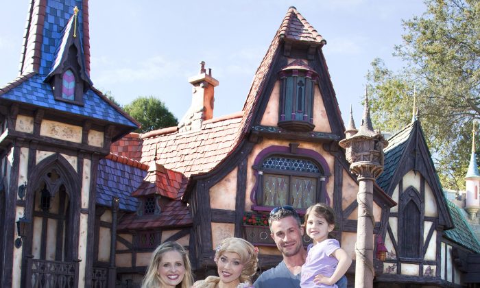 Sarah Gellar, Freddie Prinze Jr. and their daughter Charlotte, 3, meet Rapunzel at the Fantasy Faire attraction at Disneyland in Anaheim, Calif., March 6. This week, Disney reported increased second quarter traffic at its theme parks. (Paul Hiffmeyer/Disney Enterprises, Inc. via Getty Images)