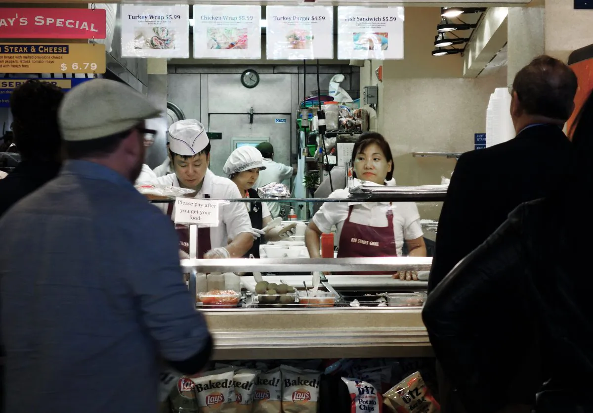 Customers wait to be served at a local neighborhood delicatessen on April 24, 2013 in downtown Washington. Americans have less disposable income while food prices are on the rise. (Paul J. Richards/AFP/Getty Images)