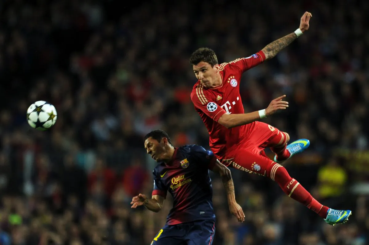 Barcelona's Brazilian defender Adriano (L) vies with Bayern Munich's Croatian striker Mario Mandzukic during the UEFA Champions League semi-final match FC Barcelona vs FC Bayern Munich on May 1, 2013. (LLuis Gene/AFP/Getty Images)