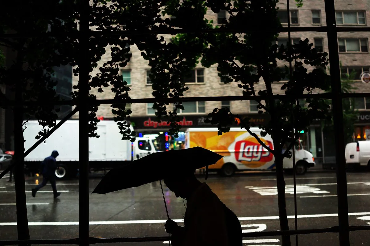 A man walks with an umbrella during a rain storm on May 8, 2013 in New York City. (Spencer Platt/Getty Images)
