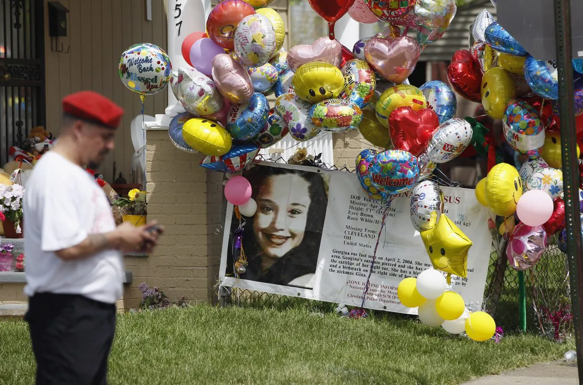 A Guardian Angel waits for the car carrying kidnap victim Gina DeJesus to arrive at her house on May 8, 2013, in Cleveland, Ohio. DeJesus was one of three women who were held captive for almost a decade in a home in Cleveland. (Matt Sullivan/Getty Images)