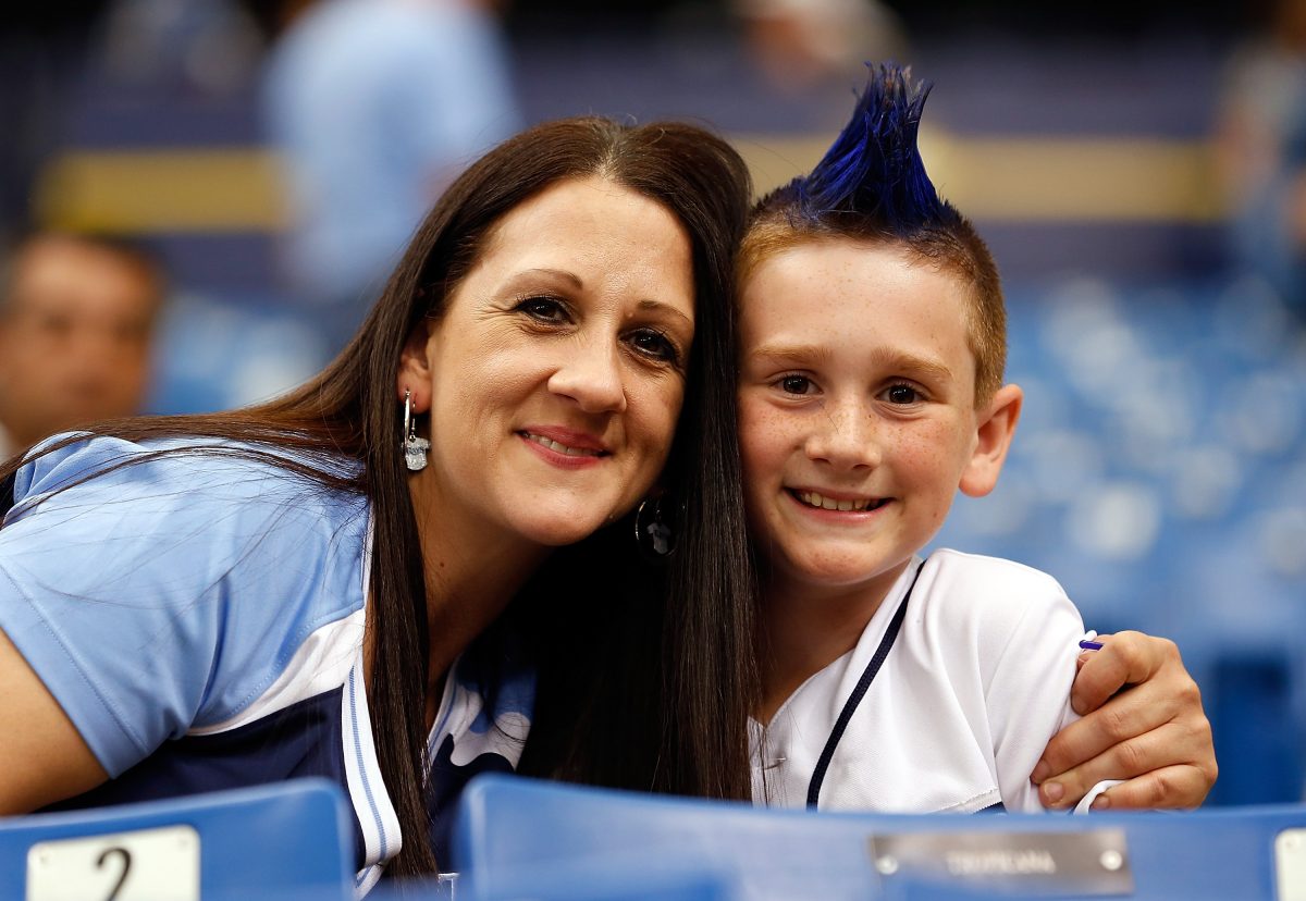 A fan of the Tampa Bay Rays smiles with his mom during the game against the San Diego Padres at Tropicana Field on May 12, 2013. (J. Meric/Getty Images) 