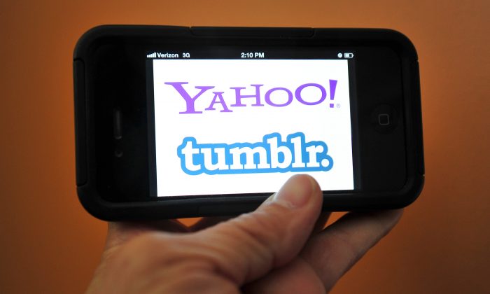 The splash page for Yahoo and blogging startup Tumblr are seen on an iPhone. Yahoo's board of directors reportedly approved the acquisition of Tumblr Sunday. (Karen Bleier/AFP/Getty Images)