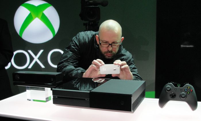 An iPhone is used to snap a picture of the next generation Xbox One videogame console at the Microsoft campus in Redmond, Wash., May 21. Microsoft touted its new Xbox as a home entertainment hub that goes far beyond games.
(Glenn Chapman/AFP/Getty Images)