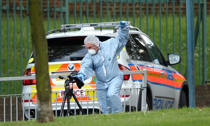 A forensic police offer photographs evidence at the scene where a soldier was butchered to death with a machete, in what officials are treating as a terrorist attack (Dan Kitwood/Getty Images)