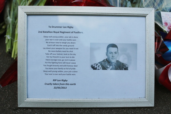 A framed picture of Drummer Lee Rigby of the 2nd Battalion the Royal Regiment of Fusiliers who was killed yesterday, lays with flowers outside Woolwich Barracks on May 23, 2013 in London, England. (Dan Kitwood/Getty Images)