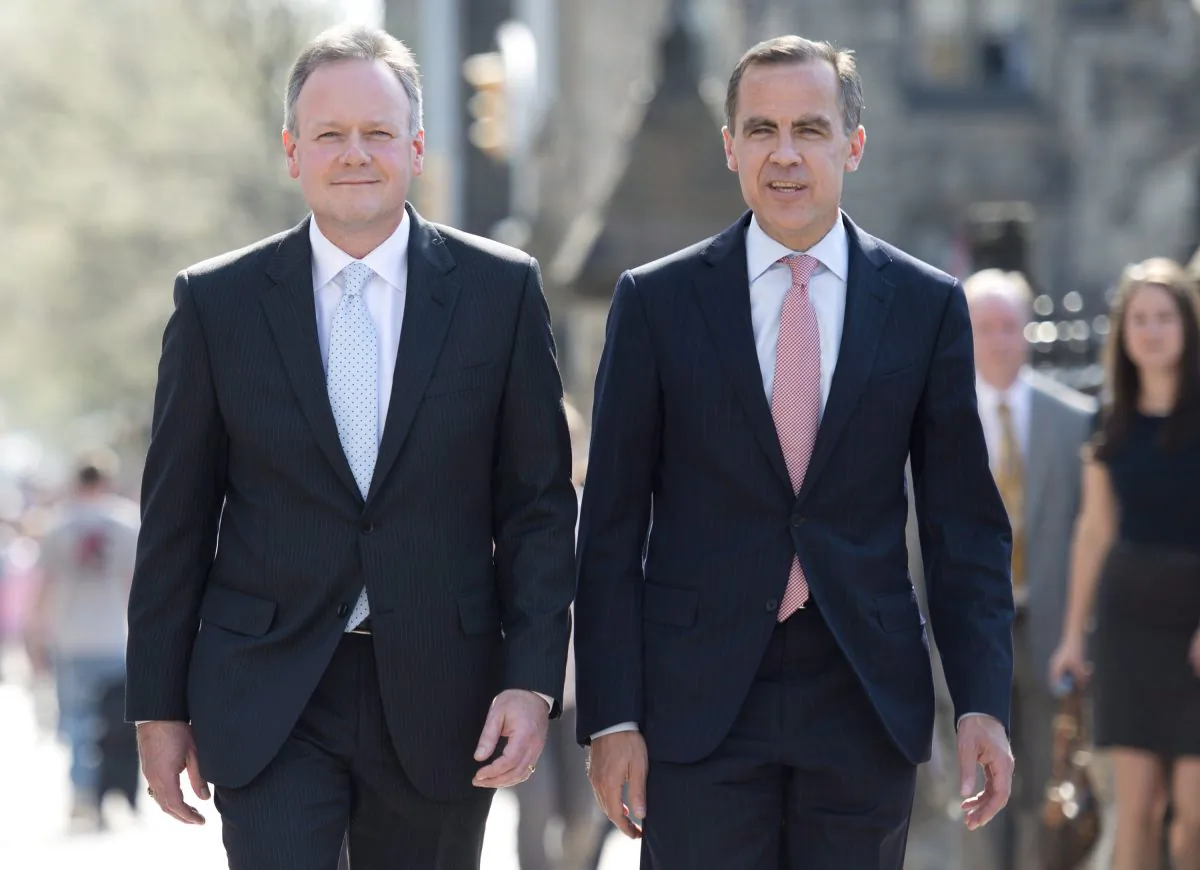 Bank of Canada Governor designate Stephen Poloz walks with outgoing Governor Mark Carney as they make their way to a news conference in Ottawa on May 2, 2013. (THE CANADIAN PRESS/Adrian Wyld)