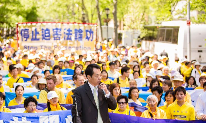 Baiqiao Tang, chairman of China Peace, and a leading Chinese dissident, speaks at a rally calling for an end to the persecution of Falun Gong in China in front of the United Nations building in New York City on May 17, 2013. (Edward Dai/The Epoch Times)
