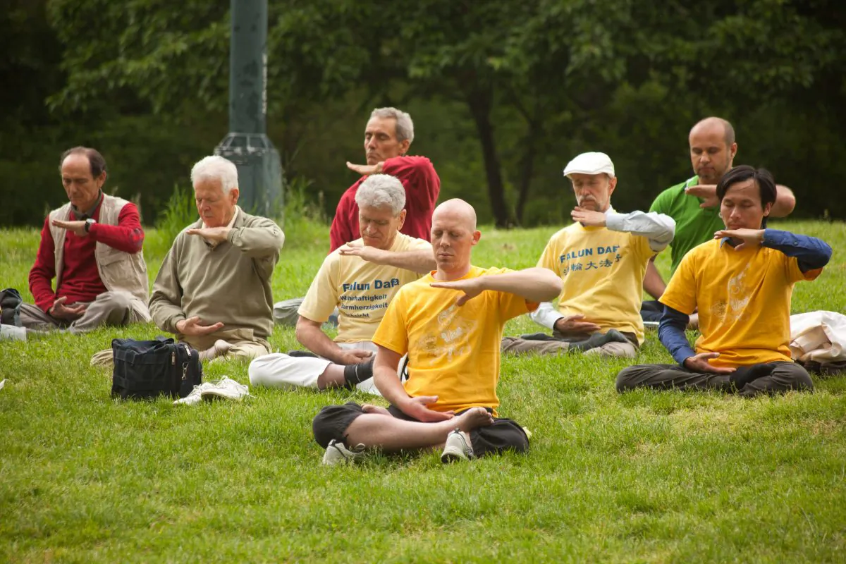 Adherents of Falun Dafa practice meditation in Central Park, New York on May 18. (Jeff Nenarella/The Epoch Times) 