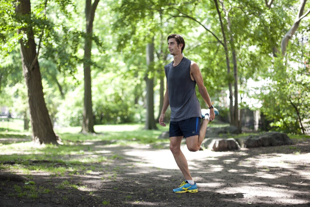 Brendan Brazier, founder of thriveforward.com, stretches in Central Park, New York on May 21. (Samira Bouaou/The Epoch Times)
