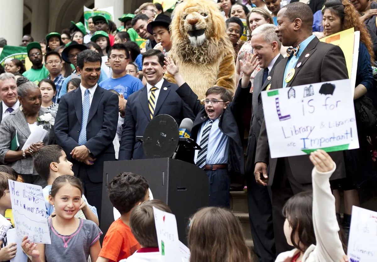 Third-grader Preston Ferraiuolo from Brooklyn speaks during a press conference on the City Hall steps to protest $106.7 million in budget cuts to public libraries. (Samira Bouaou/The Epoch Times)