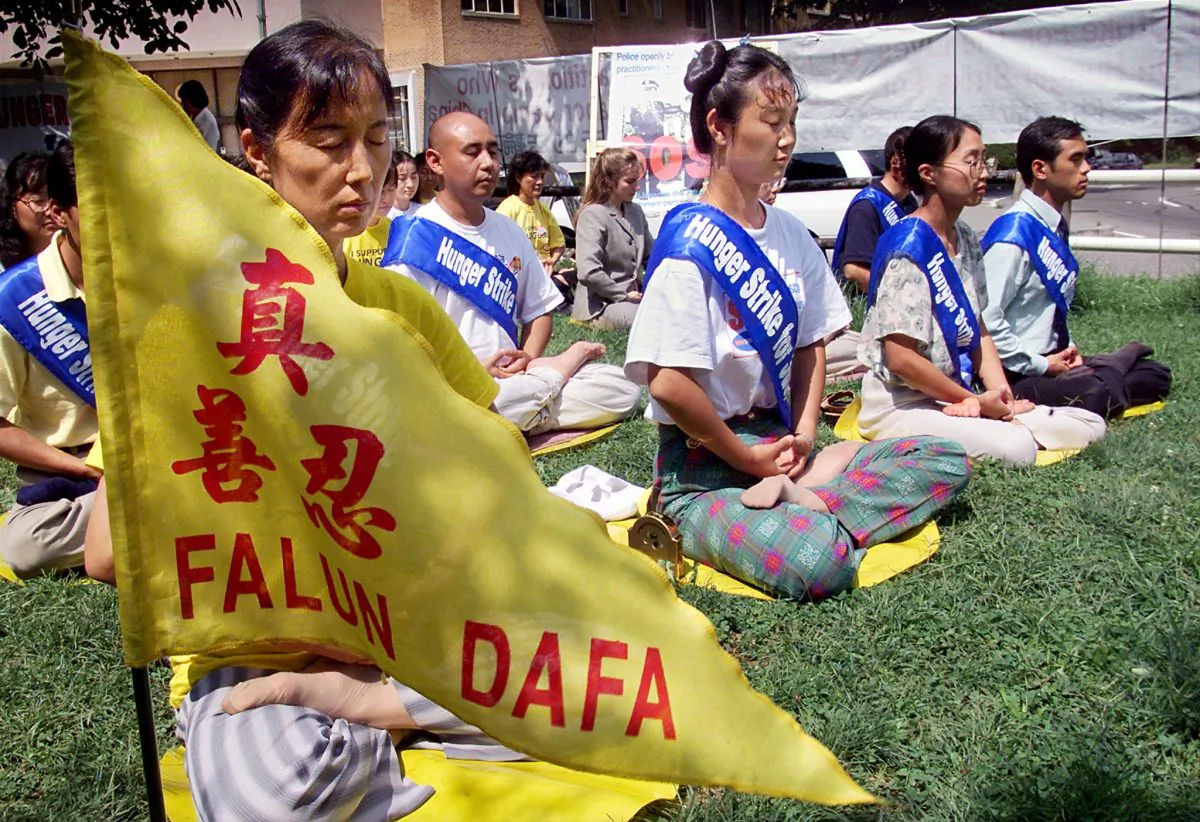 Falun Gong practitioners meditate as they enter their fourth day of a hunger strike in front of the Chinese Embassy in Washington, D.C., on Aug. 20, 2001. The practitioners held the hunger strike to call for the release of 130 practitioners imprisoned at the Masanjia Labor Camp in Liaoning Province of China. (STEPHEN JAFFE/AFP/Getty Images)
