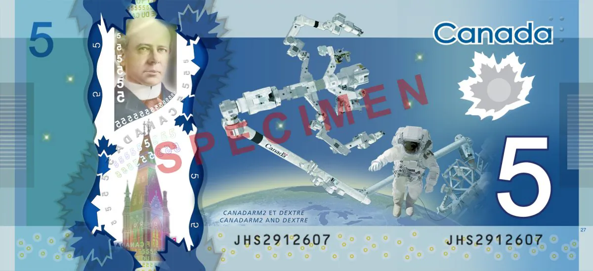 The back of the new $5 bill features images of the Canadian-built Canadarm2 and Dexte, robotic innovations used at the International Space Station, as well as a portrait of former prime minister Wilfrid Laurier. (Courtesy of Bank of Canada)