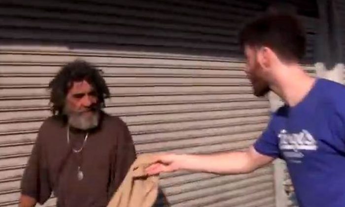 Filmmaker Greg Karber hands a man a piece of Abercrombie & Fitch clothing in East Los Angeles in a video posted to YouTube on May 13, 2013. (Screenshot/YouTube)