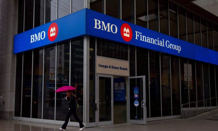 A woman leaves a Bank of Montreal branch in downtown Vancouver, B.C., on March 22, 2011. BMO Financial Group has added its voice to a chorus of Canadian banks that say they must control expenses during the current period of sluggish consumer lending. (THE CANADIAN PRESS/Darryl Dyck)