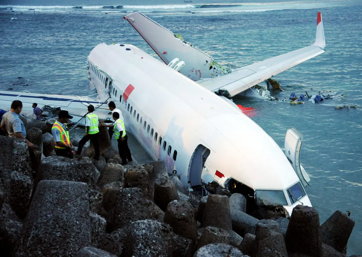 Indonesia rescuers stand by as a Lion Air Boeing 737 lies partially submerged in the water three days after it crashed while trying to land at Bali's international airport near Denpasar on April 13, 2013. (Sonny Tumbelaka/AFP/Getty Images)