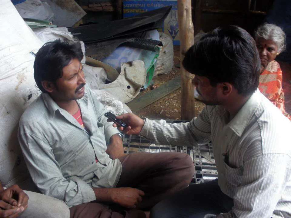 Waste-pickers record a program in a scrapyard in Nayanandahalli Slum in Bangalore. The show produces and broadcasts programs in five Indian languages—Kannada, Tamil, Telugu, Urdu and Bengal—as it caters to listeners in various slums speaking multiple languages. (Courtesy of Radio Active)