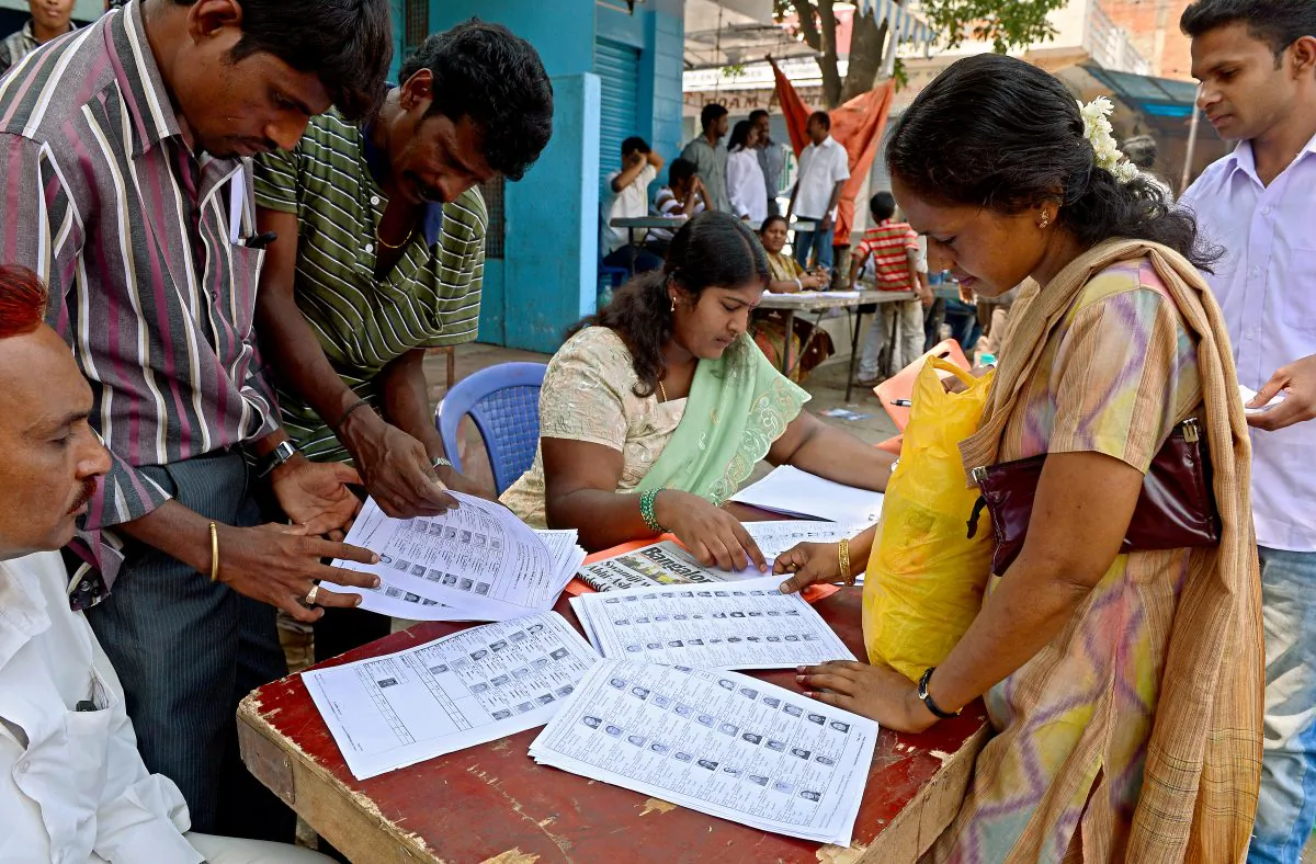 Indian voters check their names on a voters list near a polling booth during state assembly elections in Bangalore on May 5, 2013. As state elections take place across India throughout the year, activists worry about the impact of rampant list errors and obstacles to registration on democracy in India. (Manjunath Kiran/AFP/Getty Images)