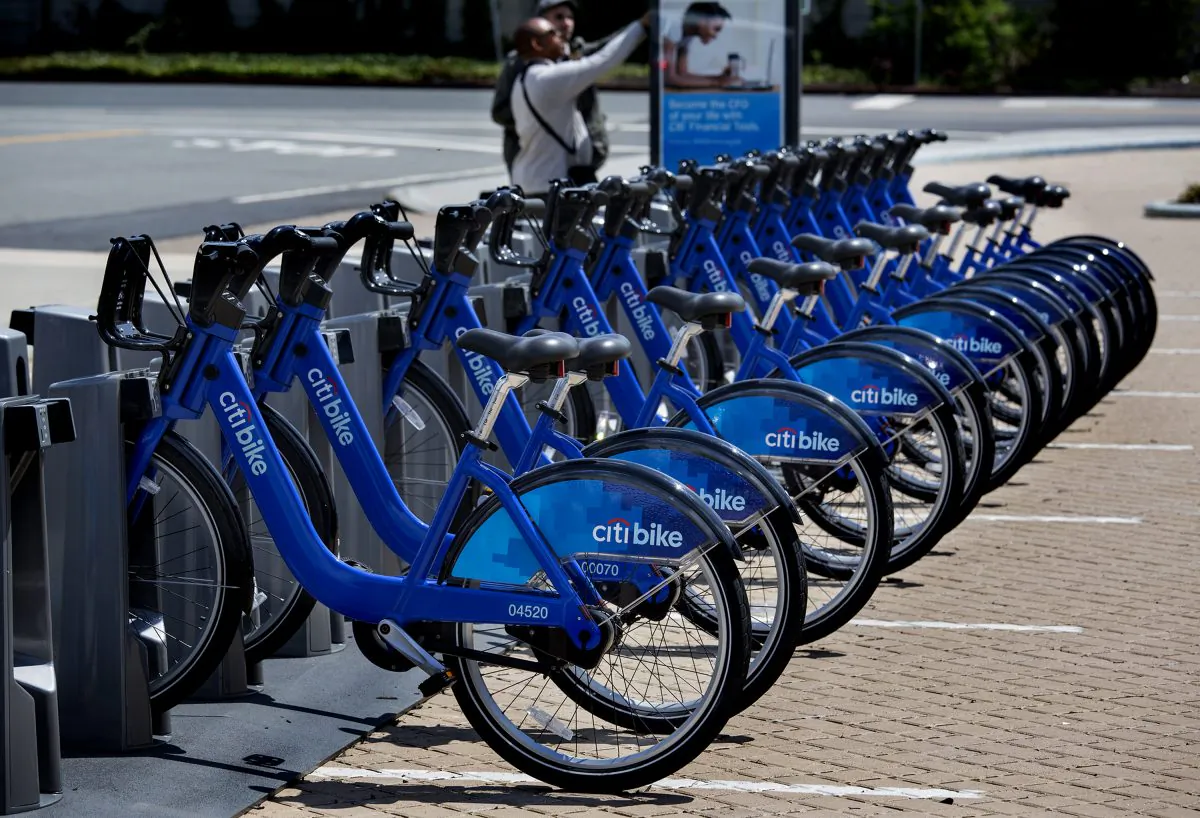 Bicycles, part of the NYC Bike Share program, are lined up at a dock and lock station at the Brooklyn Navy Yards Sunday, May 12, 2013 in New York. The expanding bike share system allows those who join to ride bicycles and return them from the same or different docks in parts of New York. (AP Photo/Craig Ruttle)