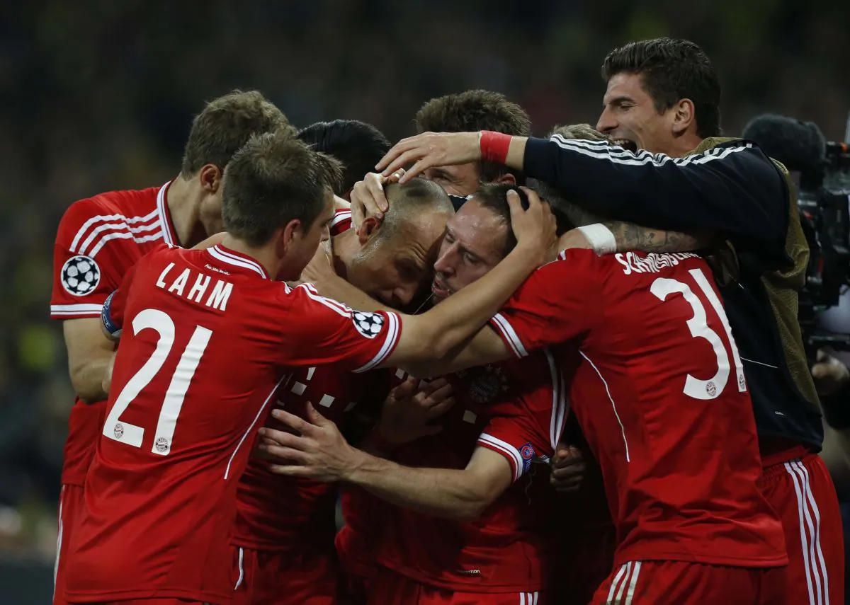 Bayern's Arjen Robben of the Netherlands, centre left, celebrates scoring the winning goal with teammates during the Champions League Final soccer match between Borussia Dortmund and Bayern Munich at Wembley Stadium in London, Saturday May 25, 2013. (AP Photo/Matt Dunham)