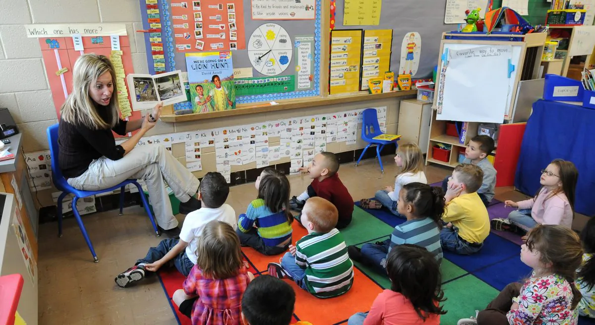 A file photo four- and five-year-old preschool students listen to their teacher, Angie Clark, read at a Des Moines Iowa elementary school on March 29, 2011. Iowa is one of the 45 states set to implement the federal Common Core standards in schools. (AP Photo/Steve Pope, File)