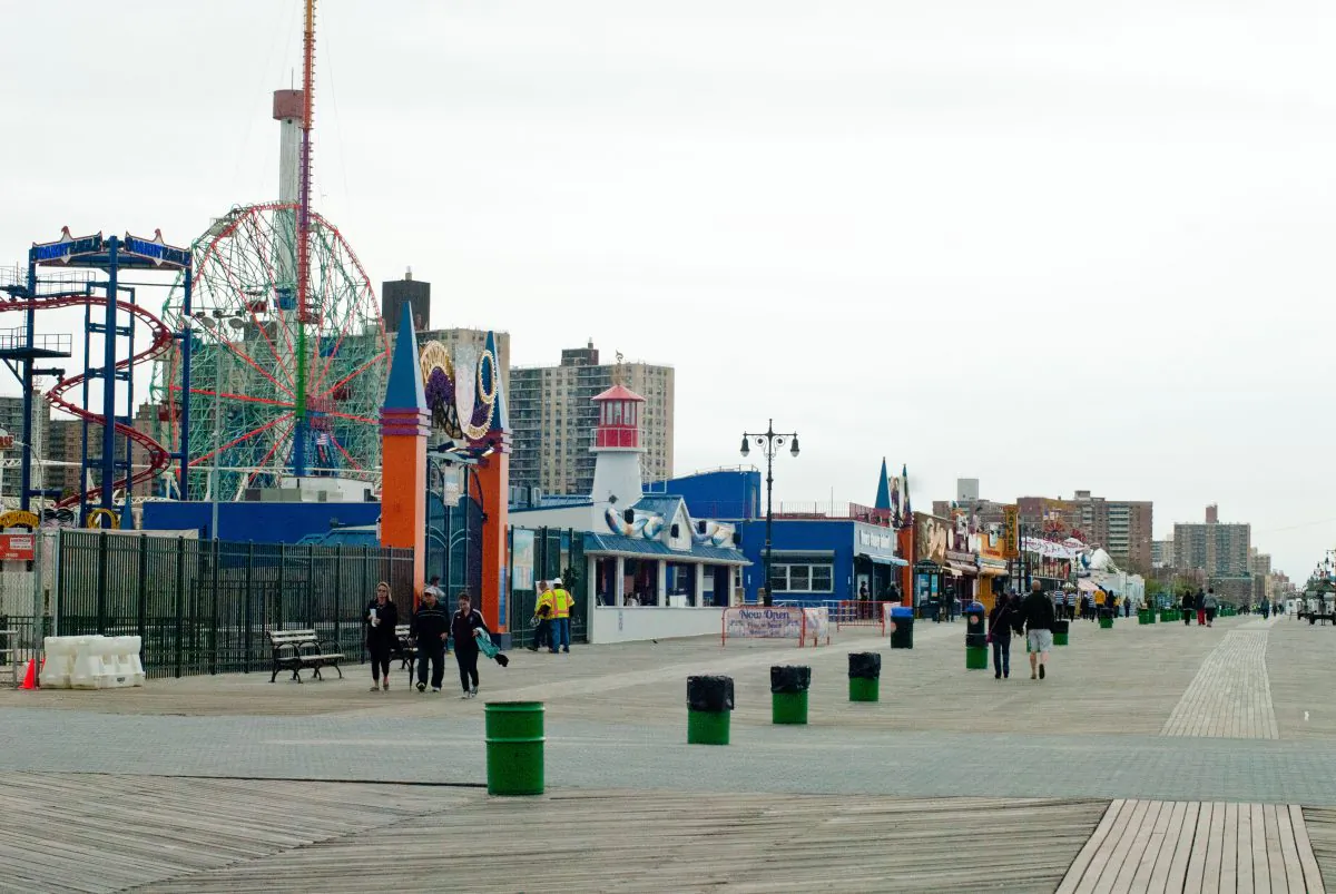 People walk along the boardwalk near Luna Park at Coney Island, New York, on March 24. With the beaches opening and Luna Park fully opening for Memorial Day weekend, repairs to damage caused by Hurricane Sandy at the amusement park are wrapping up. (Joshua Philipp/The Epoch Times)