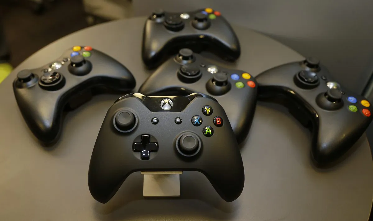 Controllers for Microsoft's Xbox One console is shown front and center with older-generation controllers behind it, in this file photo. (AP Photo/Ted S. Warren) 