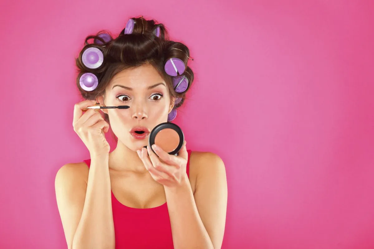 A stock photo of a woman applying mascara (photos.com)