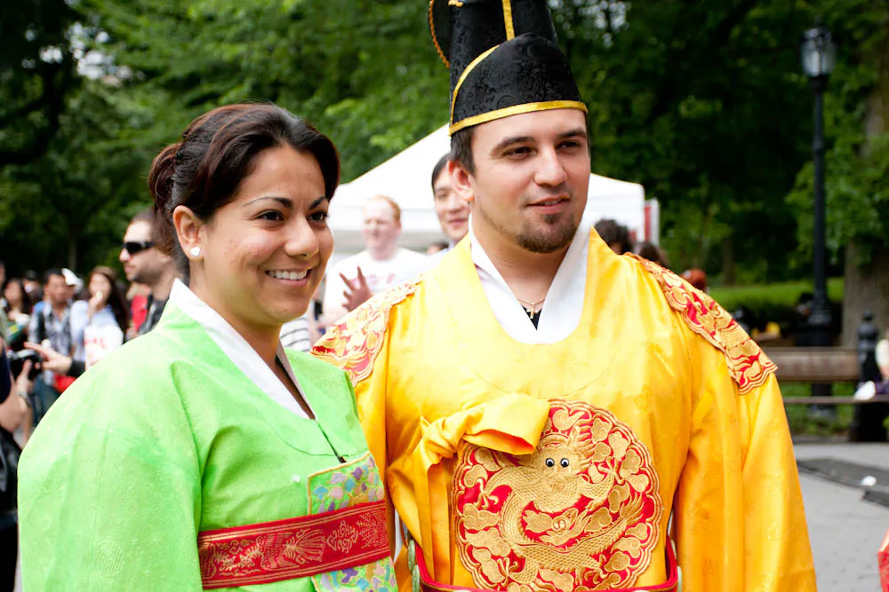 A couple dresses in traditional Korean attire at a Korea Day event in Central Park, New York City on Aug. 16, 2011. (Tara MacIsaac/The Epoch Times)