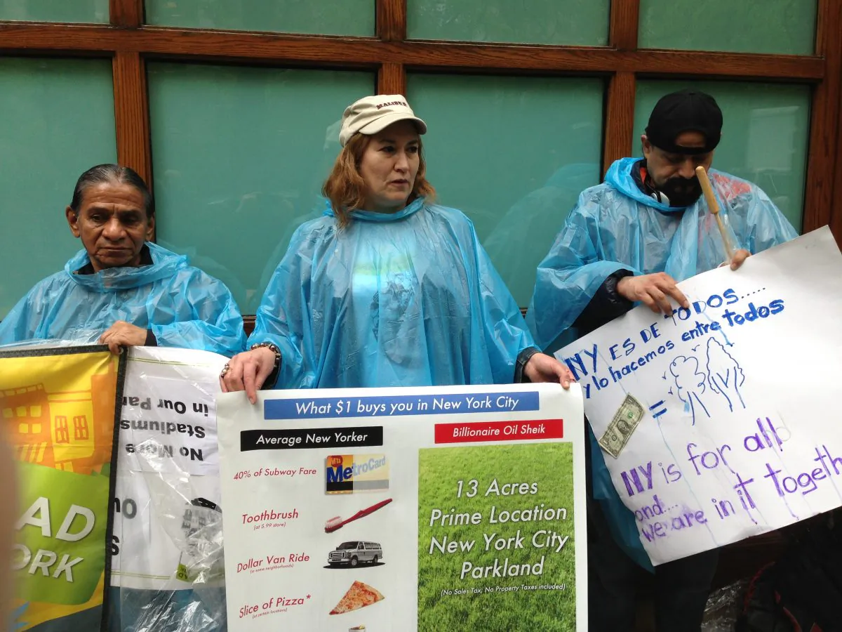People hold signs outside the Saudi embassy on May 10 protesting plans to relinquish public parkland in Flushing Meadows Corona Park to Mansour bin Zayed al-Nahyan, a billionaire Saudi sheik who would finance the construction of a soccer stadium there. (Ivan Pentchoukov/The Epoch Times)

