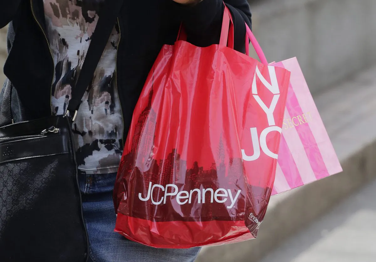 A shopper carries a J.C. Penney bag, in New York, Tues., April 9, 2013. (Mark Lennihan/AP Photo)