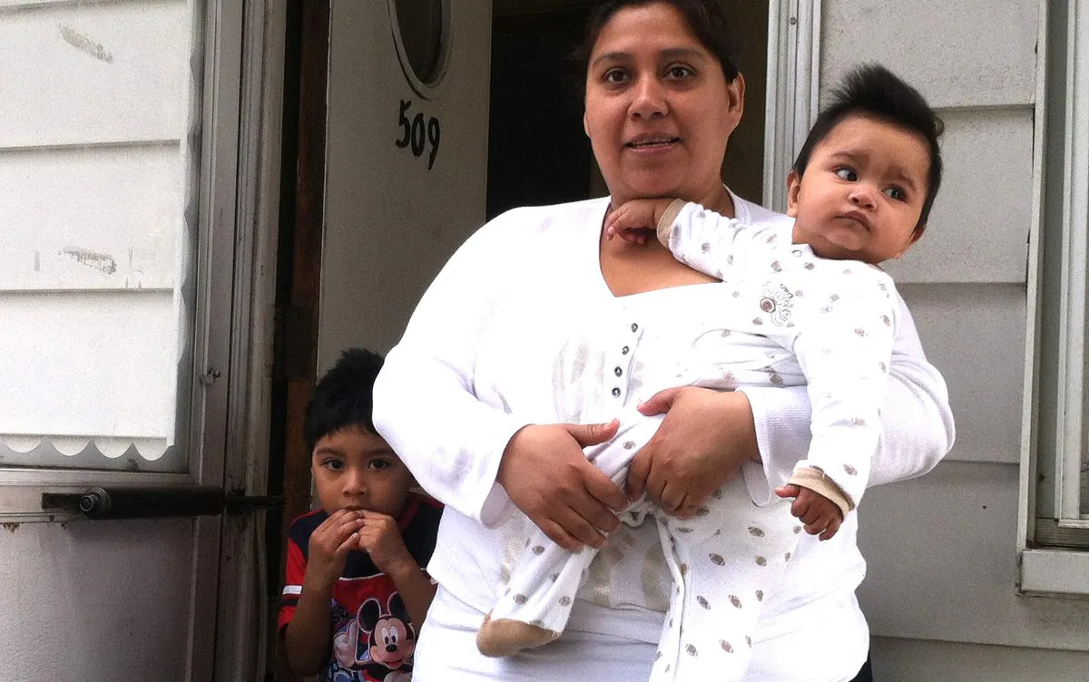 Veronica Gloria, her 8-month-old son Christian, and 4-year-old son Umberto, still have mold in their Midland Beach, Staten Island home on May 7. (Genevieve Belmaker/The Epoch Times)