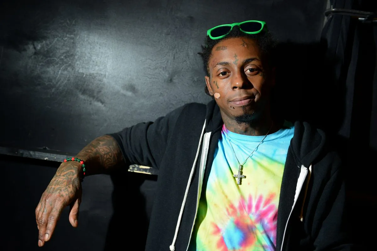 FILE - In this Feb. 1, 2013 file photo, recording artist Lil Wayne meets fans and celebrates his contemporary street wear apparel brand TRUKFIT at his hometown Macy's, in New Orleans. (Photo by Jordan Strauss/Invision/AP, File)