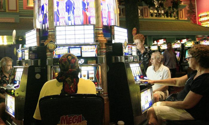 A file photo of people playing slot machines at a casino in Atlantic City, New Jersey, on Aug. 17, 2010. Overall, New Jersey's 12 casinos reported a decline in gross profits for April 2013 over April 2012 figures, with the new Revel casino reporting a 40 percent decline. (Abdullah Pope/AFP/Getty Images)