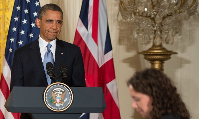 US President Barack Obama reacts to a question from the Associated Press's Julie Pace (R) during a press conference with British Prime Minister David Cameron (not seen) at the White House in Washington on May 13, 2013. (JIM WATSON/AFP/Getty Images)