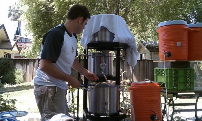 A man uses a homebrewing installation to brew beer. (Courtesy of Derek Wolfgram)
