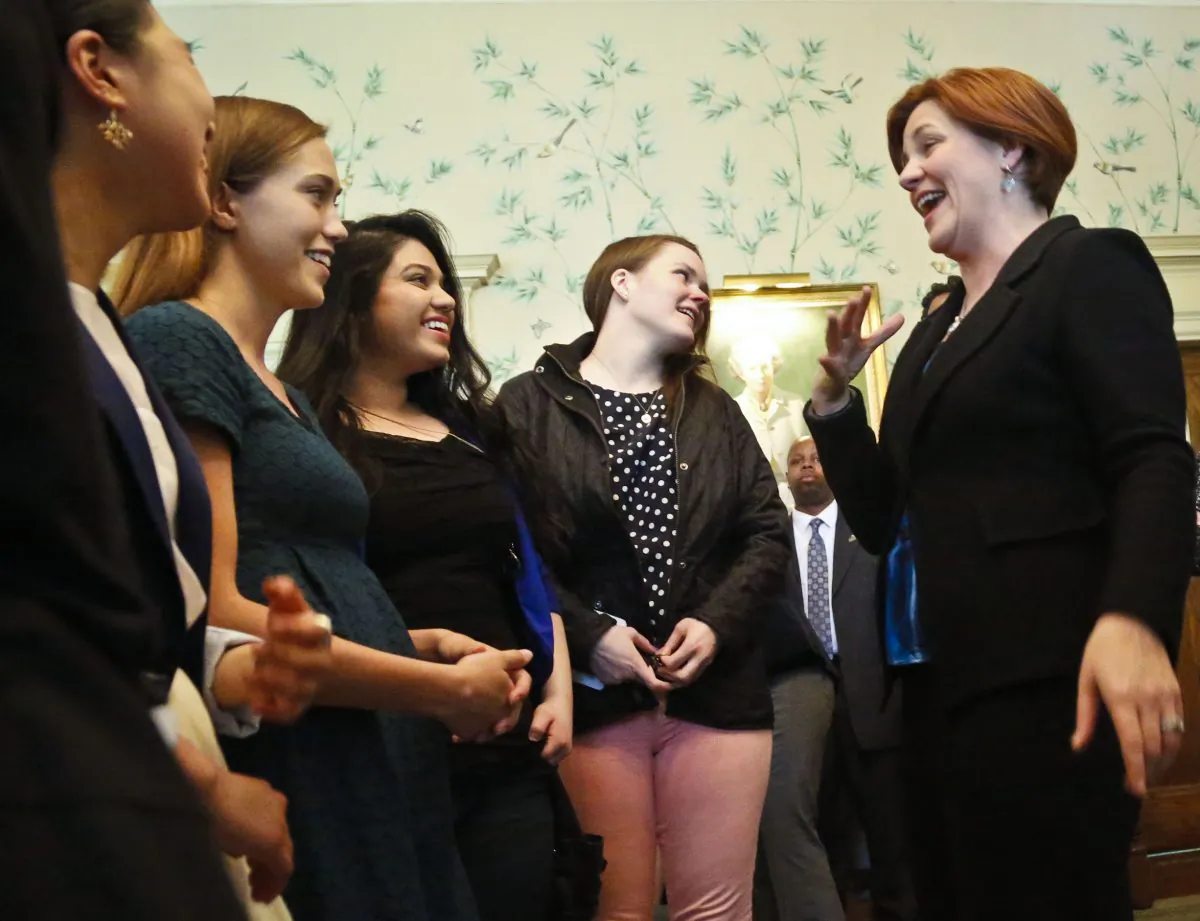 City Council Speaker Christine Quinn, far right, reacts while speaking with Rarnard College students on Tuesday, May 14, 2013, in New York. Quinn, a Democratic mayoral candidate, revealed during a wellness discussion she struggled in the past with bulimia and alcoholism starting at age 16. (AP Photo/Bebeto Matthews)