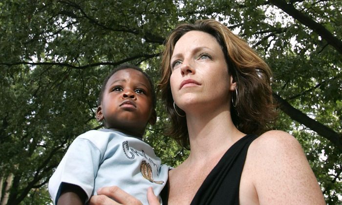 A file photo of a mother, Eden Atwood, and her son, Benjamin Anderson listening during a rally to remember the freeing of slaves in America in Memphis, Tenn. on Aug. 13, 2005. (Carlo Allegri/Getty Images)