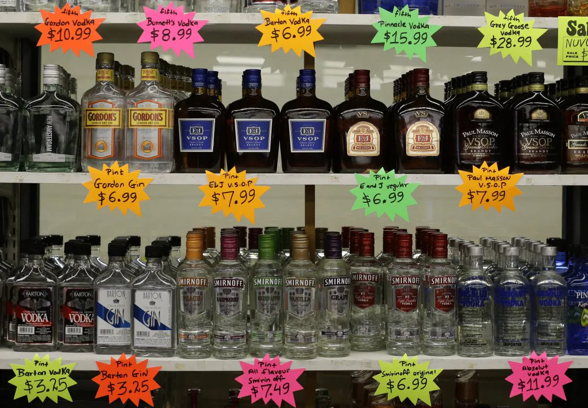 Liquor bottles in a super market in Baltimore in this file photo. Despite record stimulus measures, consumer prices have hardly increased.(AP Photo/Patrick Semansky)