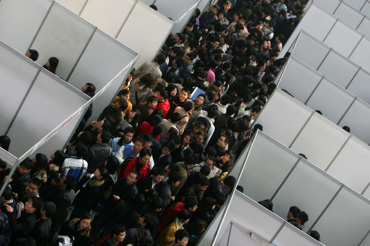 Job seekers visit a job fair for graduating university students at the Qujiang International Convention and Exhibition Center in 2009 in Shaanxi Province. A new study shows that the children of officials in the Chinese Communist Party get a 15 percent higher starting salary on average than peers with a similar education. (China Photos/Getty Images)