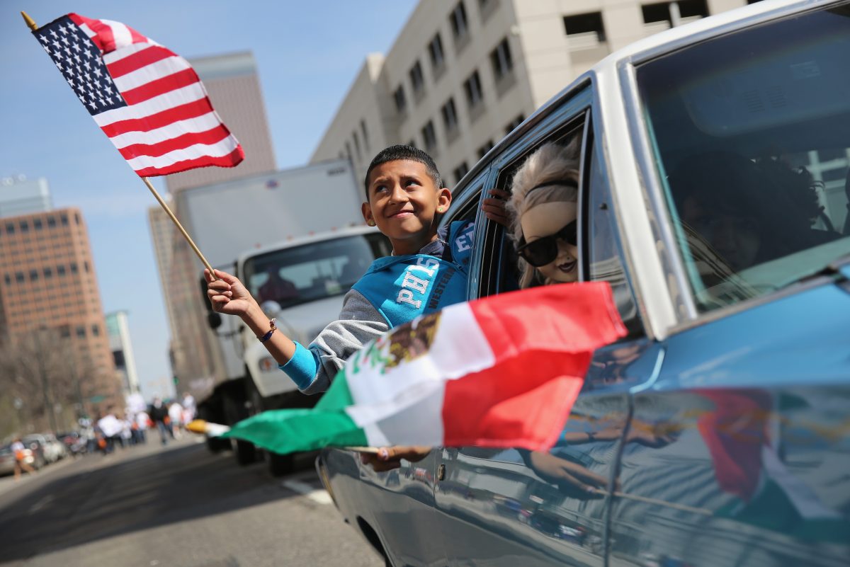 A boy rides in a low rider during a Cinco de Mayo parade in Denver, Colorado on May 4, 2013. (John Moore/Getty Images)