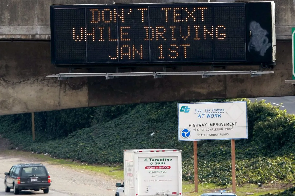 Cars drive on Interstate 280 by a notification of a texting while driving law in San Francisco, Calif. on Dec. 29, 2008. A survey published May 5, 2013, shows many such laws in the United States are not being enforced. (Justin Sullivan/Getty Images)