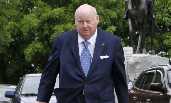 Sen. Mike Duffy makes his way to the Senate on Parliament Hill in Ottawa, Canada, on May 28, 2013. (The Canadian Press/Fred Chartrand)