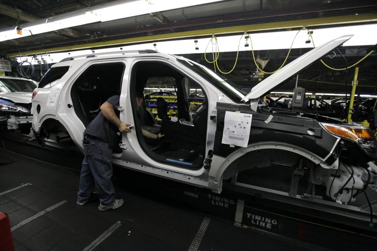In this Dec. 1, 2010 file photo, plant employees assemble a 2011 Ford Explorer on the assembly line at Ford's Chicago Assembly Plant. (AP Photo/M. Spencer Green)