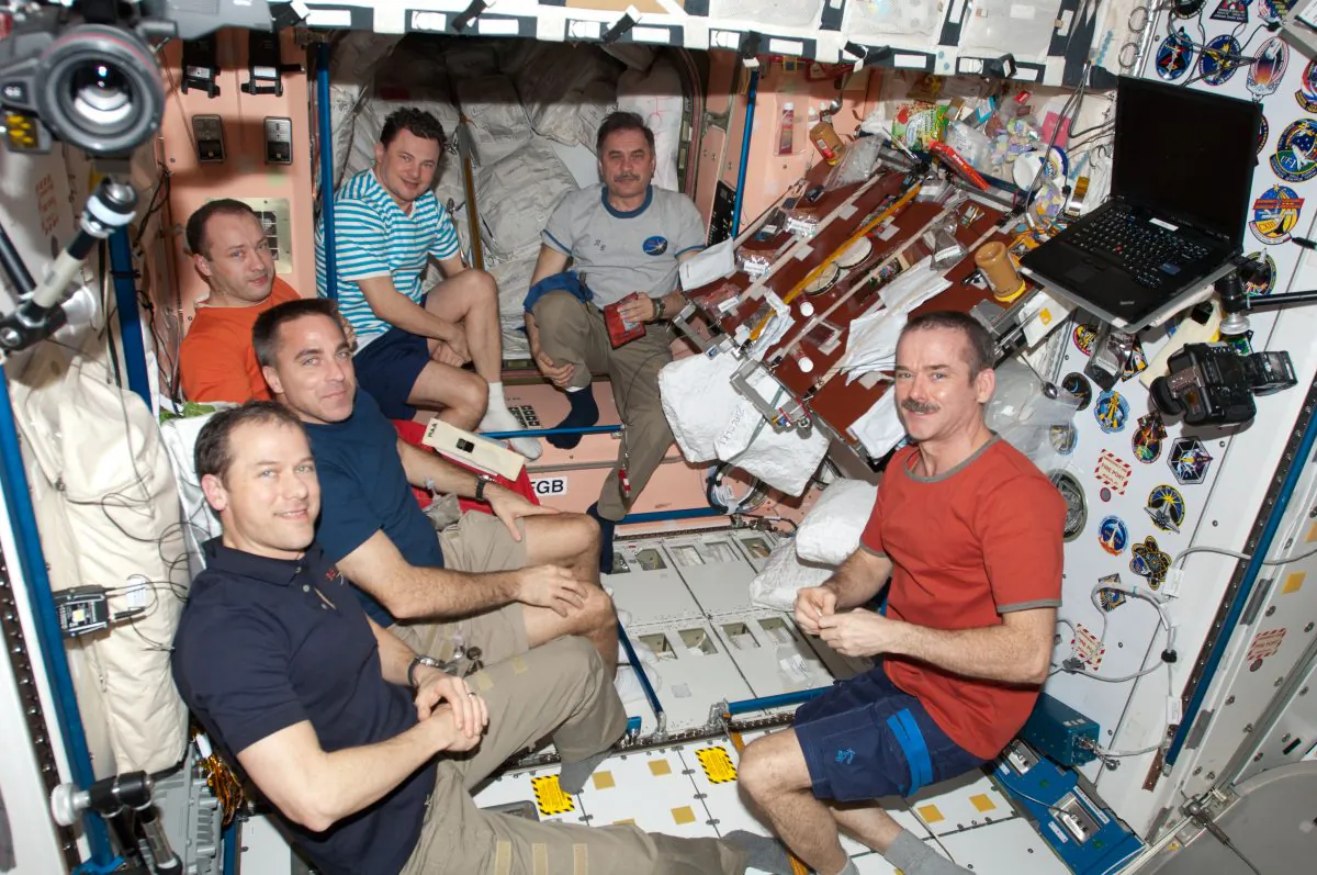 Outgoing Expedition 35 Commander Chris Hadfield of the Canadian Space Agency is at right. Clockwise from his position are the five flight engineers -- NASA astronauts Tom Marshburn and Chris Cassidy, and Russian cosmonauts Alexander Misurkin, Roman Romanenko and Pavel Vinogradov. (NASA)