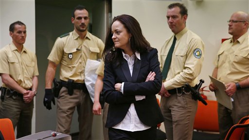 Beate Zschaepe, member of the neo-Nazi group National Socialist Underground (NSU) enters the court room before the start of her trial in Munich, southern Germany, Monday, May 6, 2013. The highest-profile neo-Nazi murder trial in Germany in decades opened Monday amid tight security and intense media interest, with the five accused appearing in public for the first time since their arrest more than a year ago. (AP Photo/Matthias Schrader)