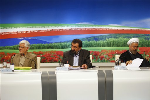 In this photo released by the Islamic Republic of Iran Broadcasting May 31, 2013, presidential candidates from left, Mohammad Reza Aref, Mohsen Rezaei, and Hasan Rowhani, attend a TV debate, in a state-run TV studio, in Tehran, Iran. (AP Photo/Islamic Republic of Iran Broadcasting, Mehdi Dehghan)